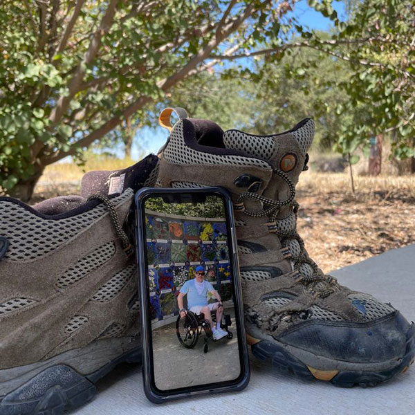 Phone leaning against hiking boots