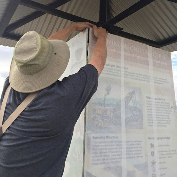 Man installing interpretive signage at Capay Open Space Park