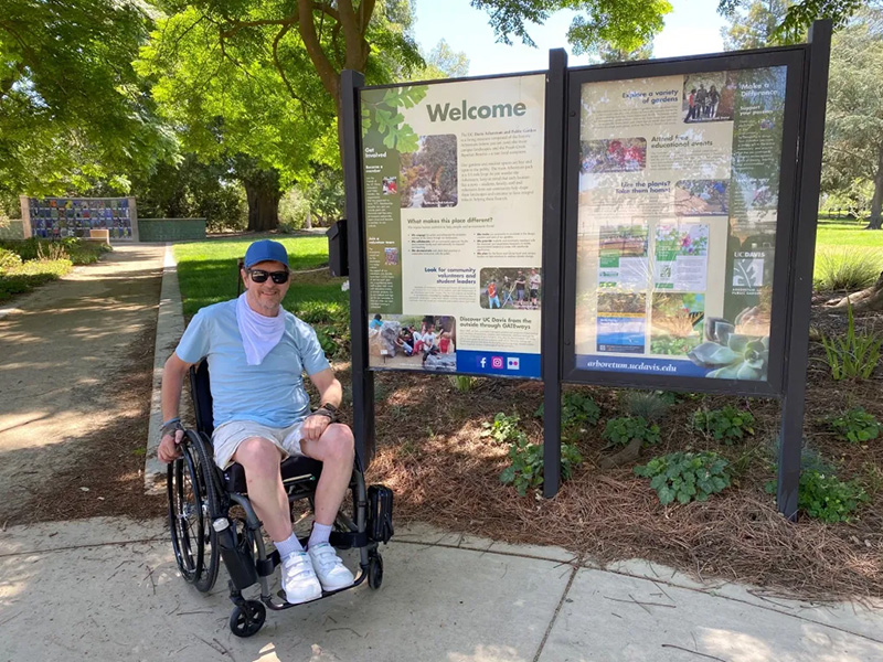 Man in wheelchair at UC Davis Arboretum entrance