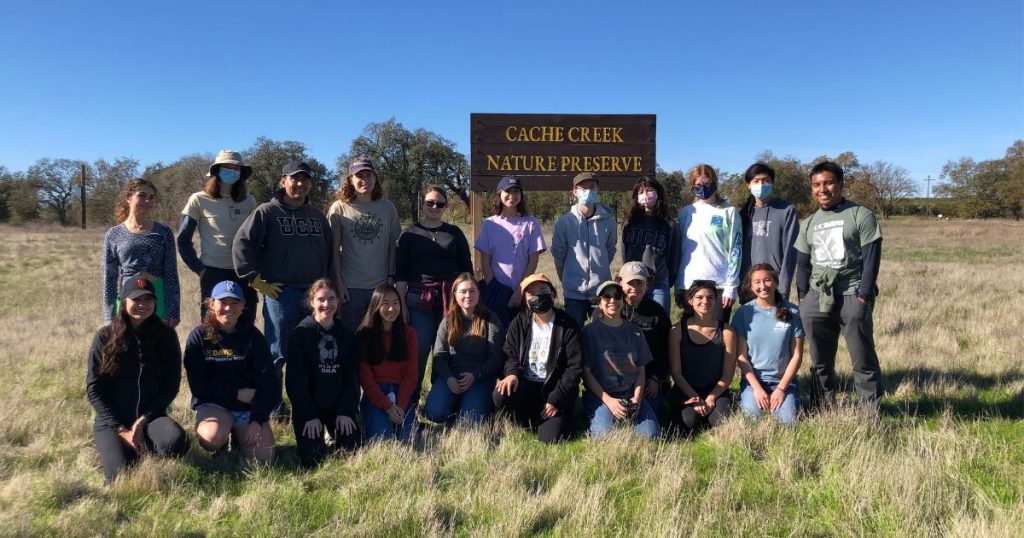 Youth group members gathered in front of sign for photo at Cache Creek Nature Preserve