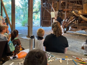 Children listening to a speaker in the Historic Barn at Cache Creek Nature Preserve