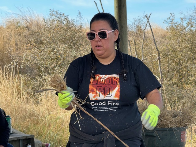 Chrissy Almendariz demonstrating how to wrap carrying torches at Leok Po 2023