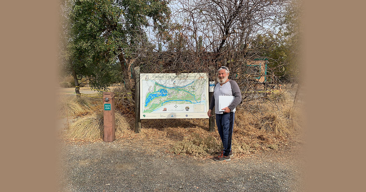 jovial fellow with beard in front of map kiosk at the Cache Creek Nature Preserve